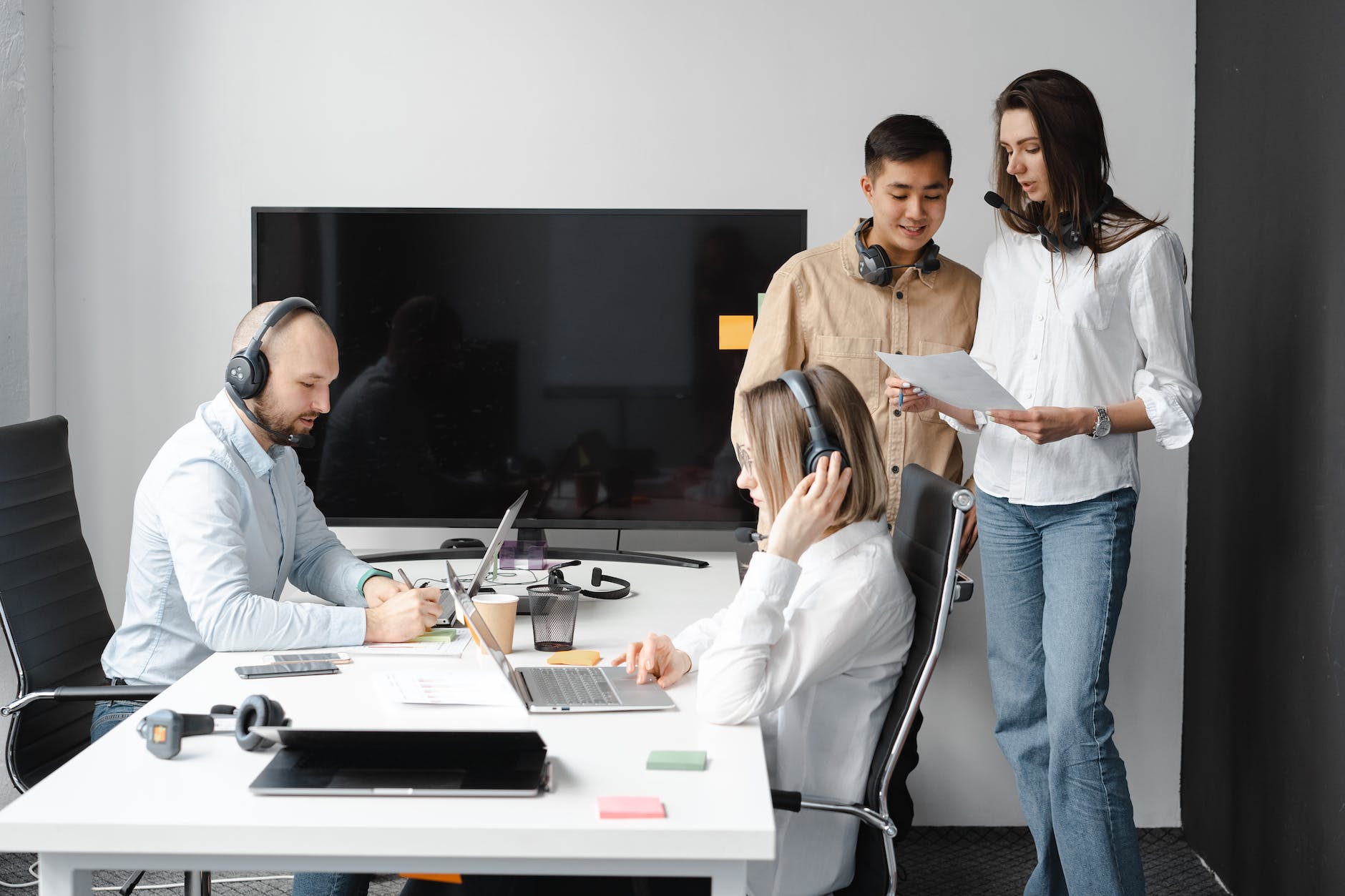 photo of a group of people with headsets in an office